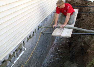 cement being pumped for basement wall repair